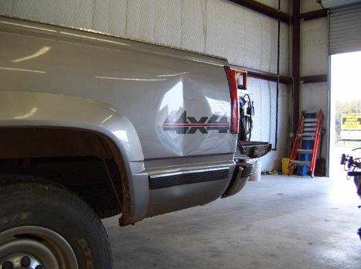 Large dent on bed of truck before